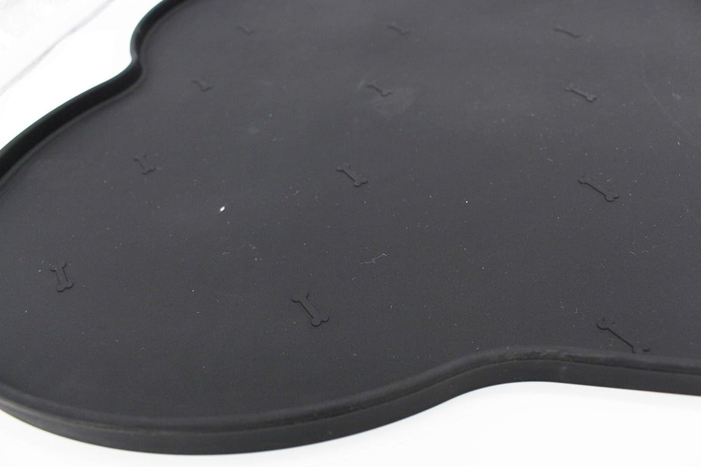 Silicone anti-spill pet feeding mat in waterproof, non-slip bone shape by Loom and Latch, designed to keep bowls in place.