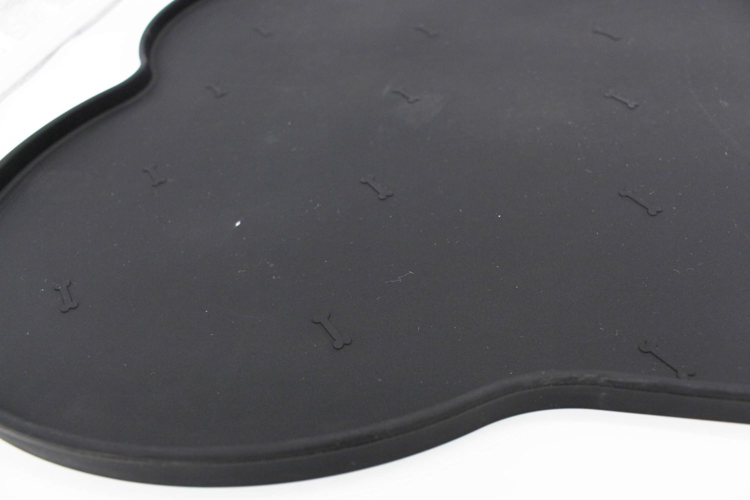 Silicone anti-spill pet feeding mat in waterproof, non-slip bone shape by Loom and Latch, designed to keep bowls in place.