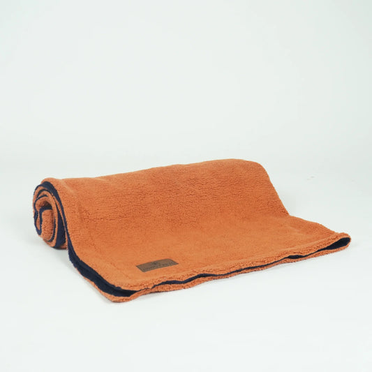 Reversible pet blanket from Loom and Latch with navy and rust soft furry fabric for dogs and cats.