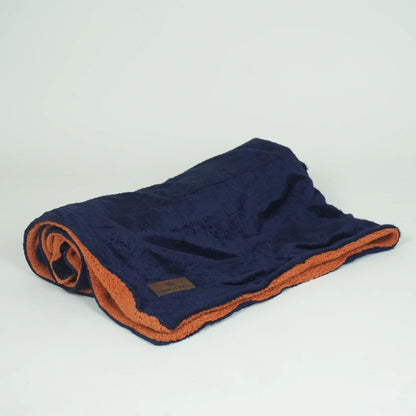 Reversible pet blanket by Loom and Latch with navy and rust soft furry fabric, suitable for dogs and cats.